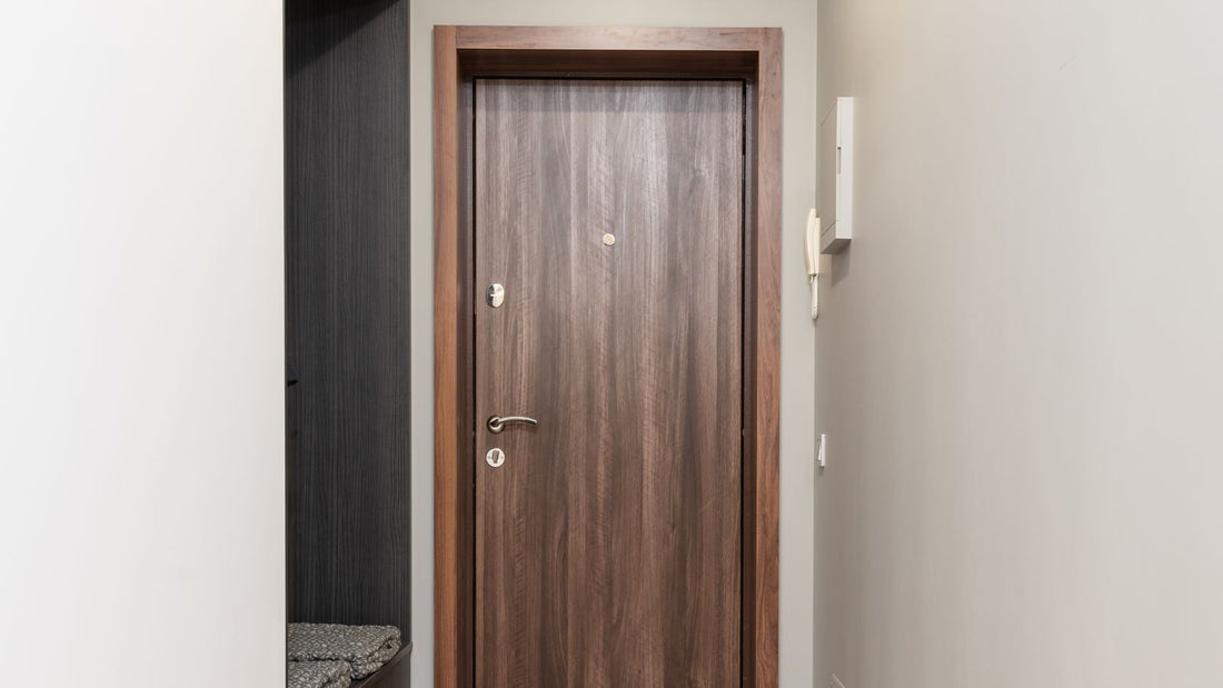 Flat internal door in a bright hallway beside a timber storage unit