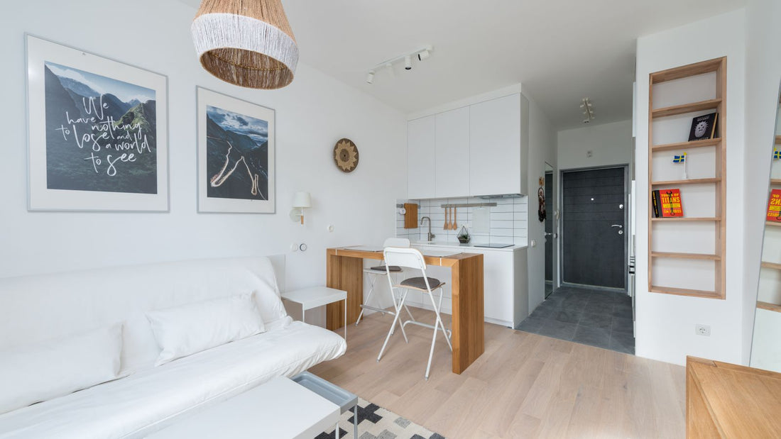Bright compact apartment with a small kitchen and light timber furniture