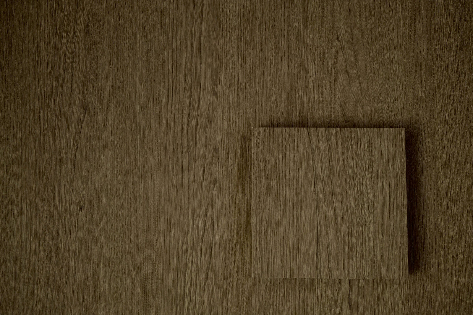Taupe rift oak vinyl wrap surface with a square sample tile, suited to internal doors
