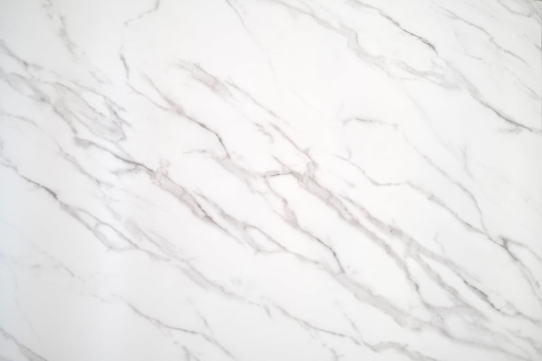 Calacatta White Marble vinyl wrap with an ivory-white surface and flowing grey veins, full surface view