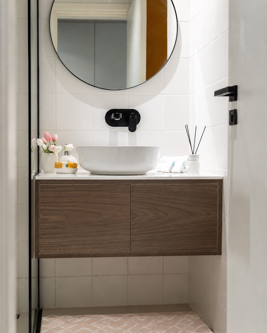 A small powder room with a floating vanity wrapped in Castello Walnut