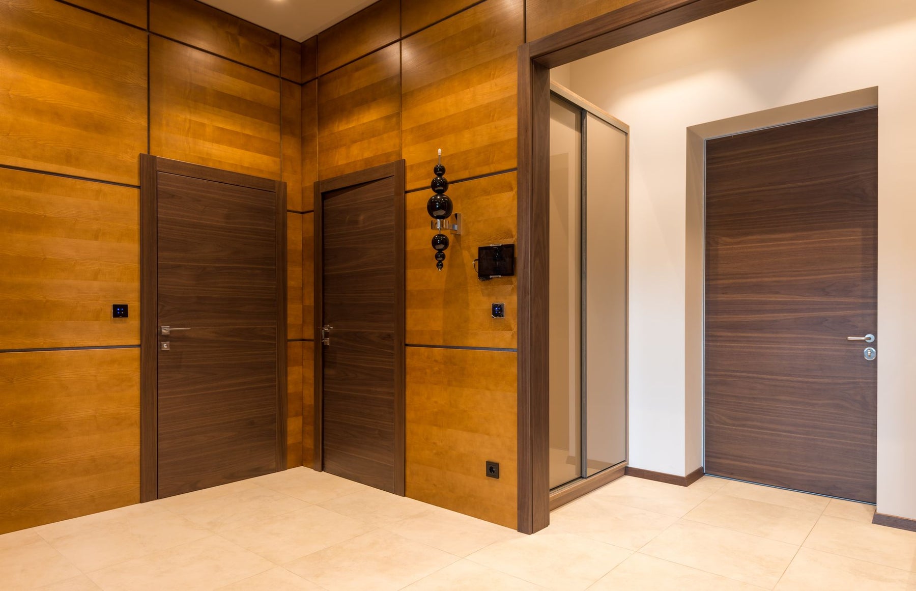 Dark woodgrain internal doors in a contemporary hallway