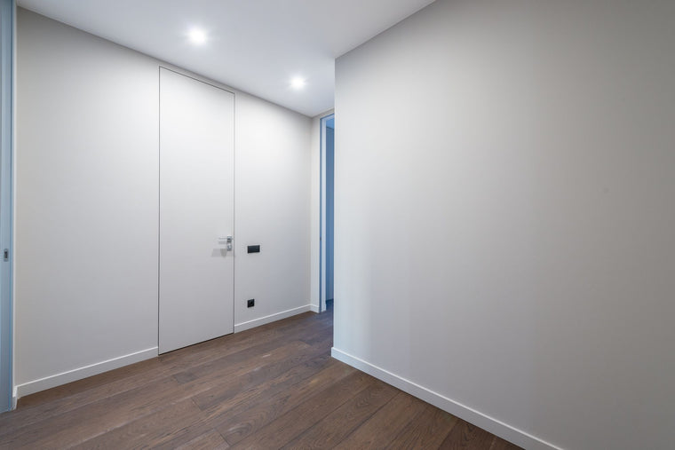 Flush internal door set into a smooth interior wall
