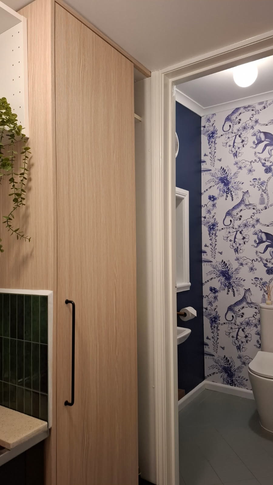 Laundry after its refresh, with tall cabinetry wrapped in Linen Oak