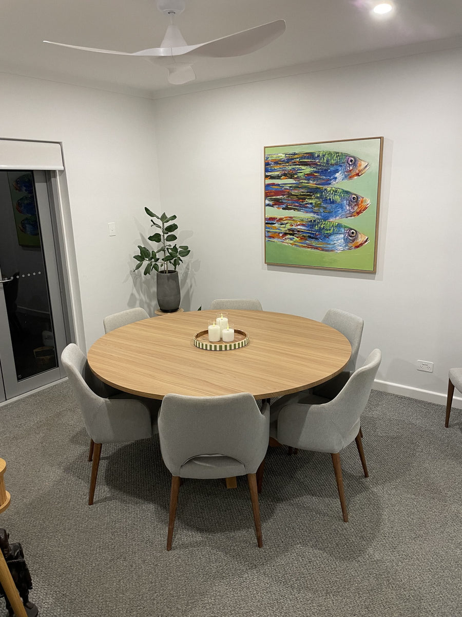Customer dining room with the round table fully wrapped in Toasted Teak wood grain