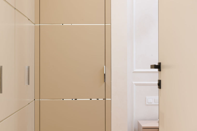 Wardrobe fronts beside an internal door in a light interior
