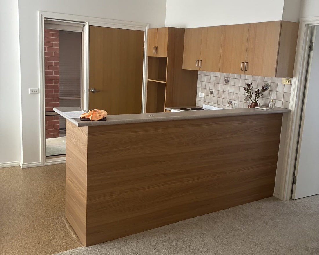 Kitchen island after its Toasted Teak vinyl wrap refresh, showing a rich brown wood-grain finish