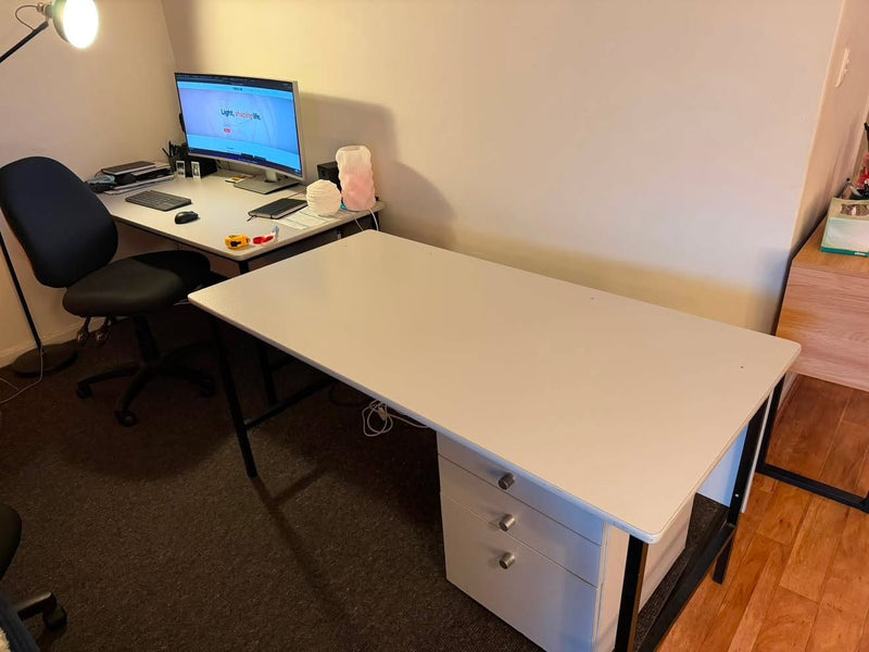 Home office before, with a plain white desk and drawer unit