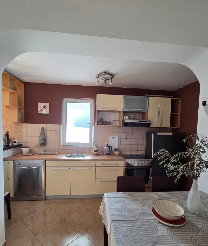 Customer kitchen before its makeover, with pale yellow laminate cabinet doors