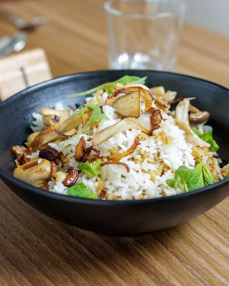 A bowl of food on a restaurant tabletop wrapped in Saddle Teak wood grain